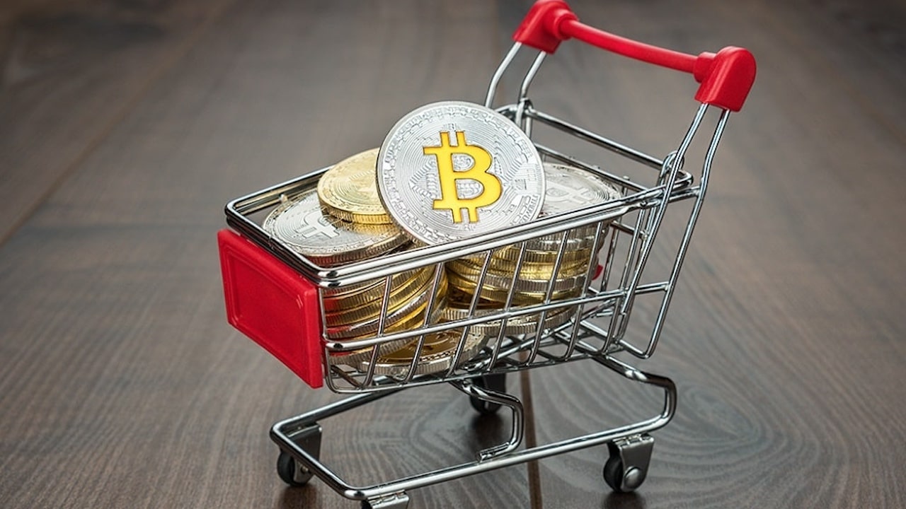 bitcoin and crypto coins in a shopping cart